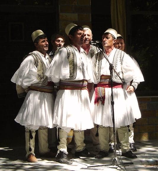 A circle of southern Albanian singers in traditional clothes performing iso-polyphony
