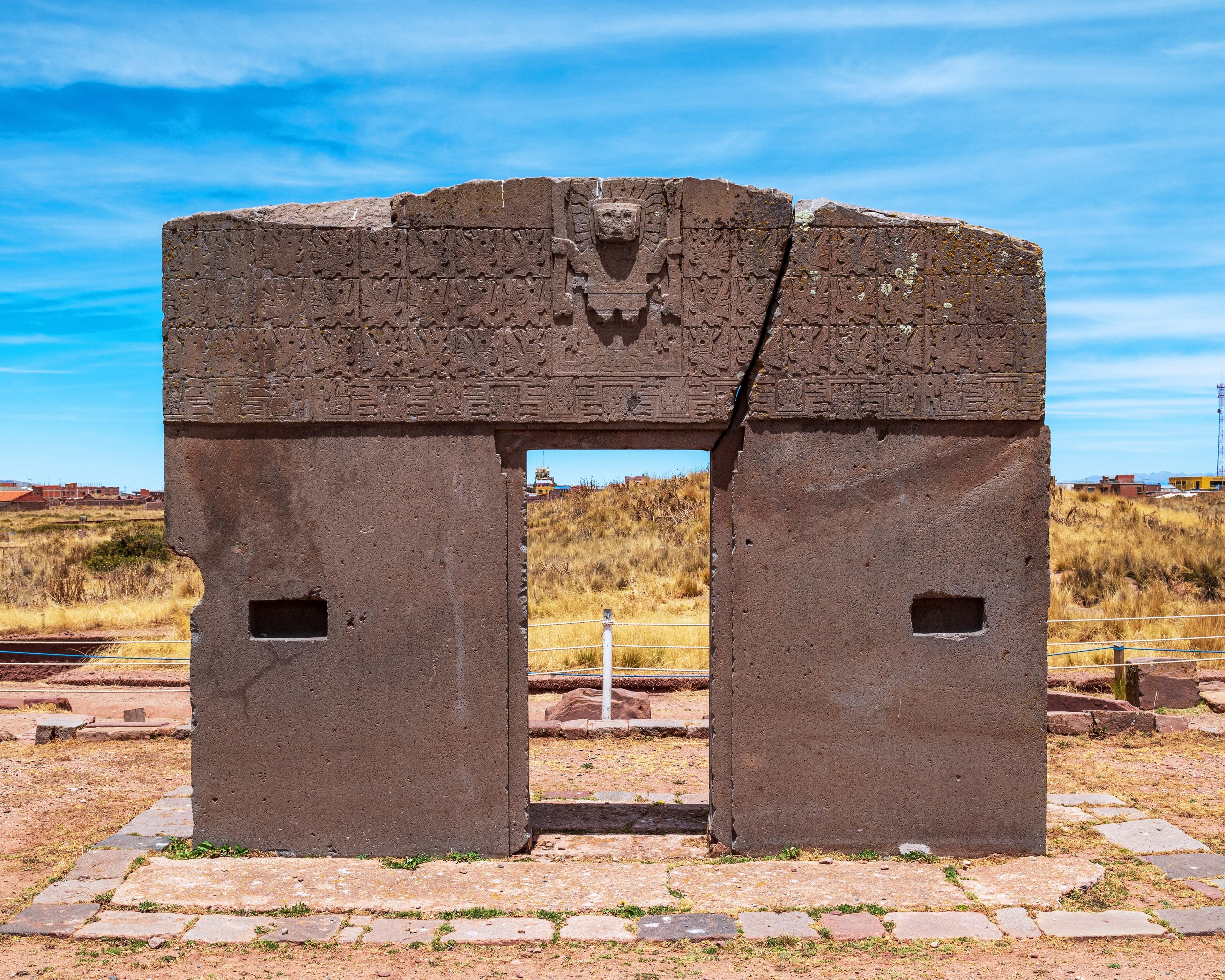 The Gate of the Sun at Tiwanaku, carved from a single block of stone against a blue sky