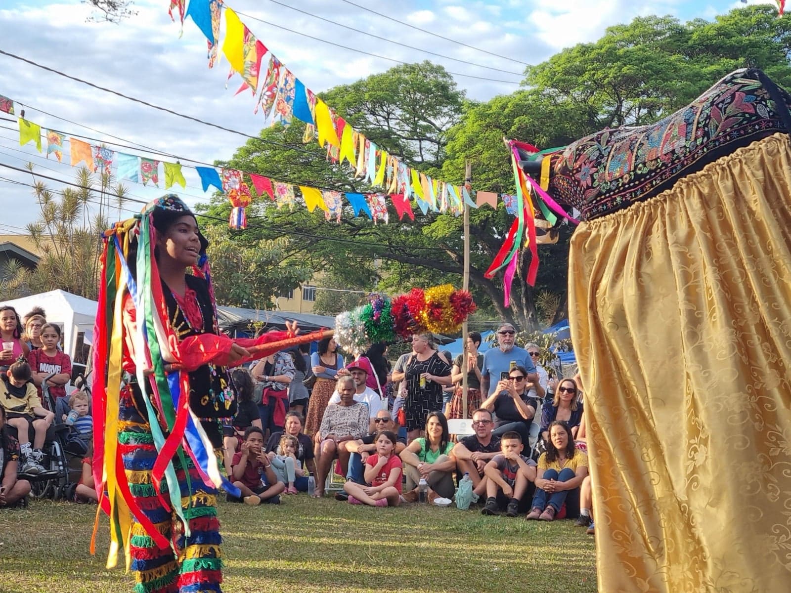 A Festa Junina celebration with colourful bunting and a dancer in costume
