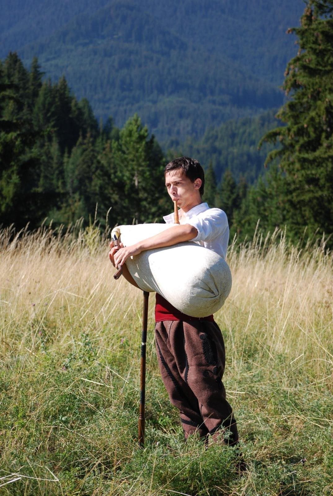 A Bulgarian folk musician playing the gaida bagpipes in traditional costume