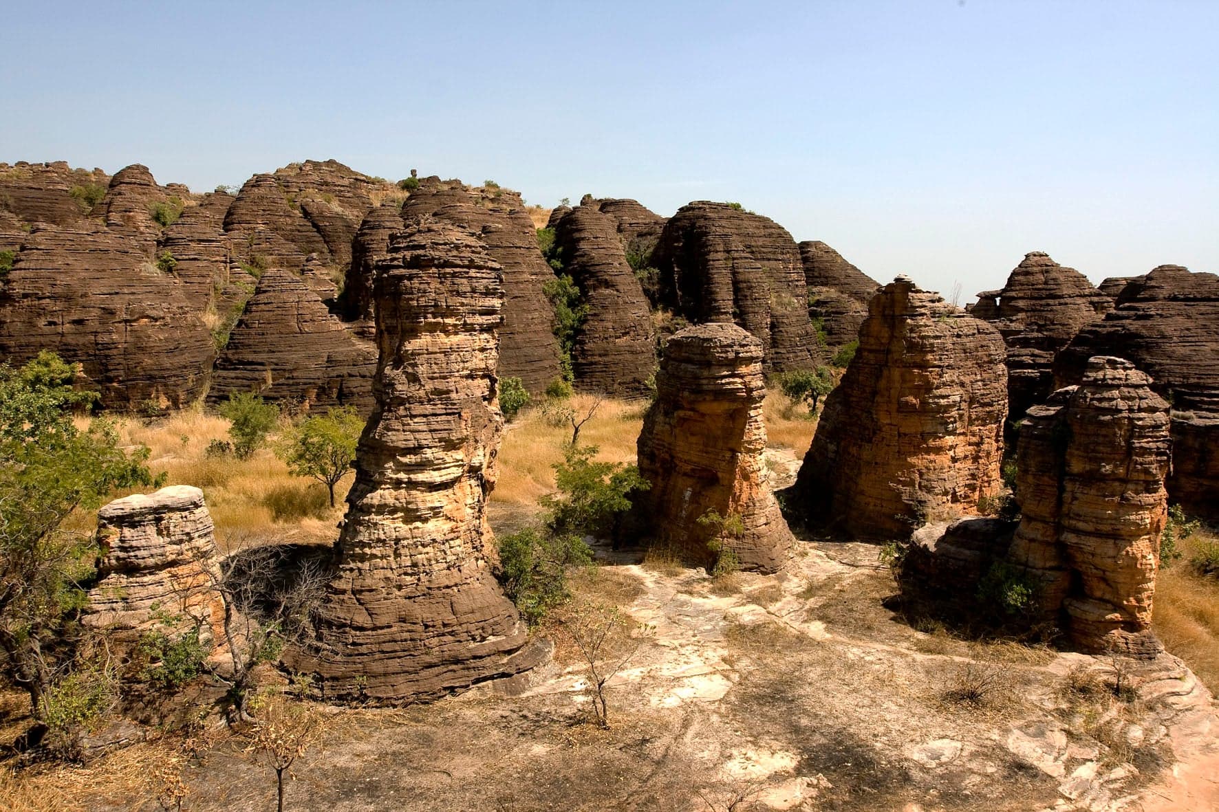 Rounded granite domes of Fabedougou rising above green savanna