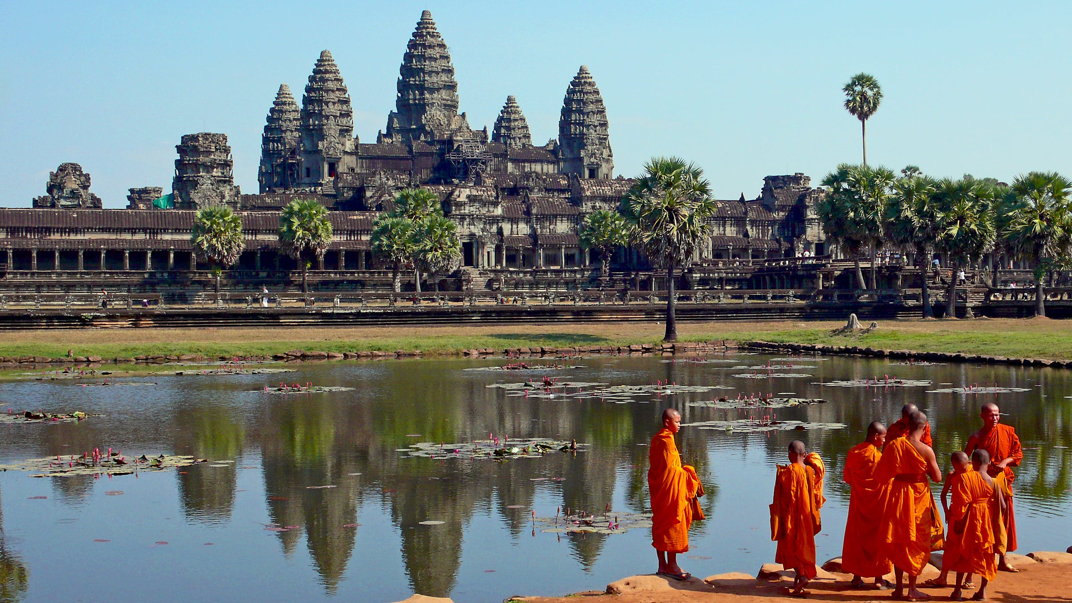The five towers of Angkor Wat reflected in the long pool at sunrise