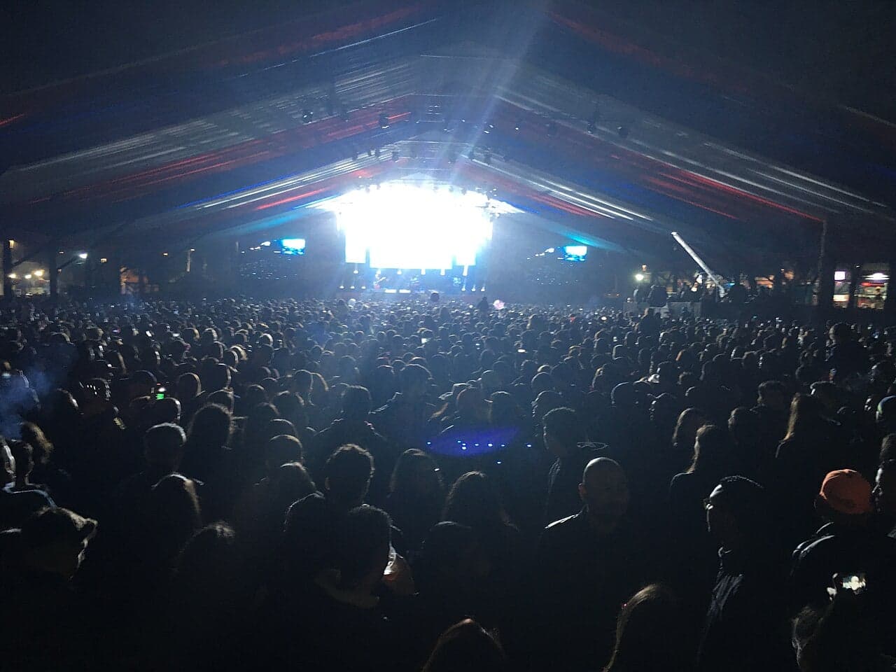 A brightly decorated Chilean fondas with paper bunting, flags and people dancing the cueca at night