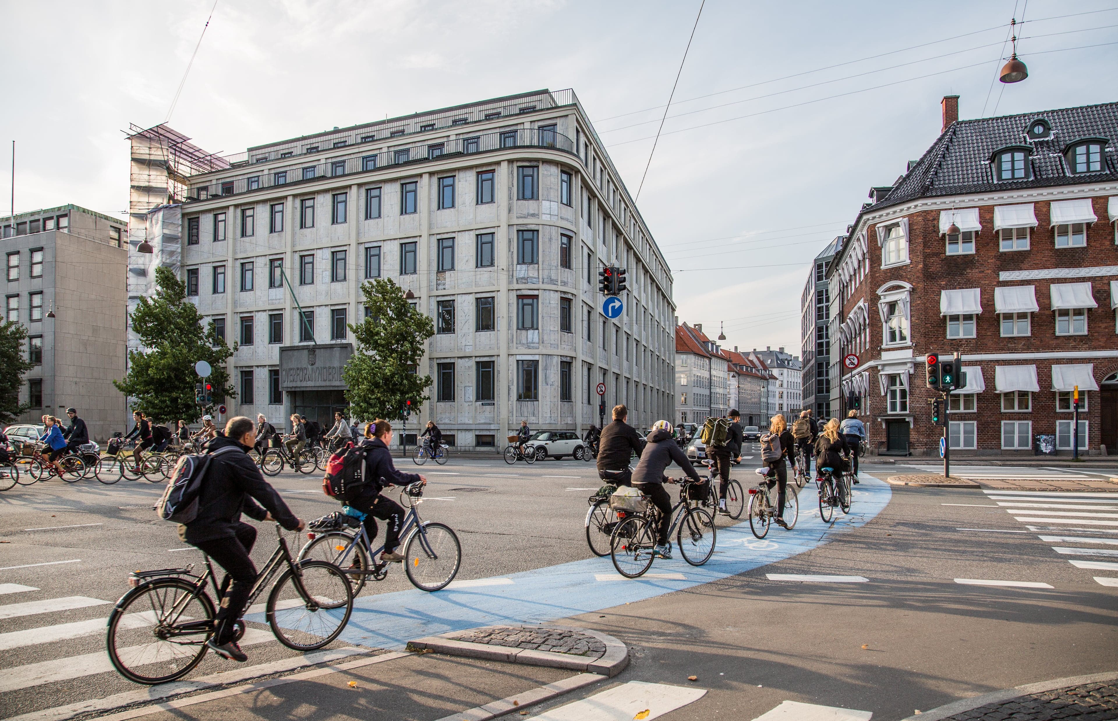 Bicycles parked in a long row beside a canal in Copenhagen