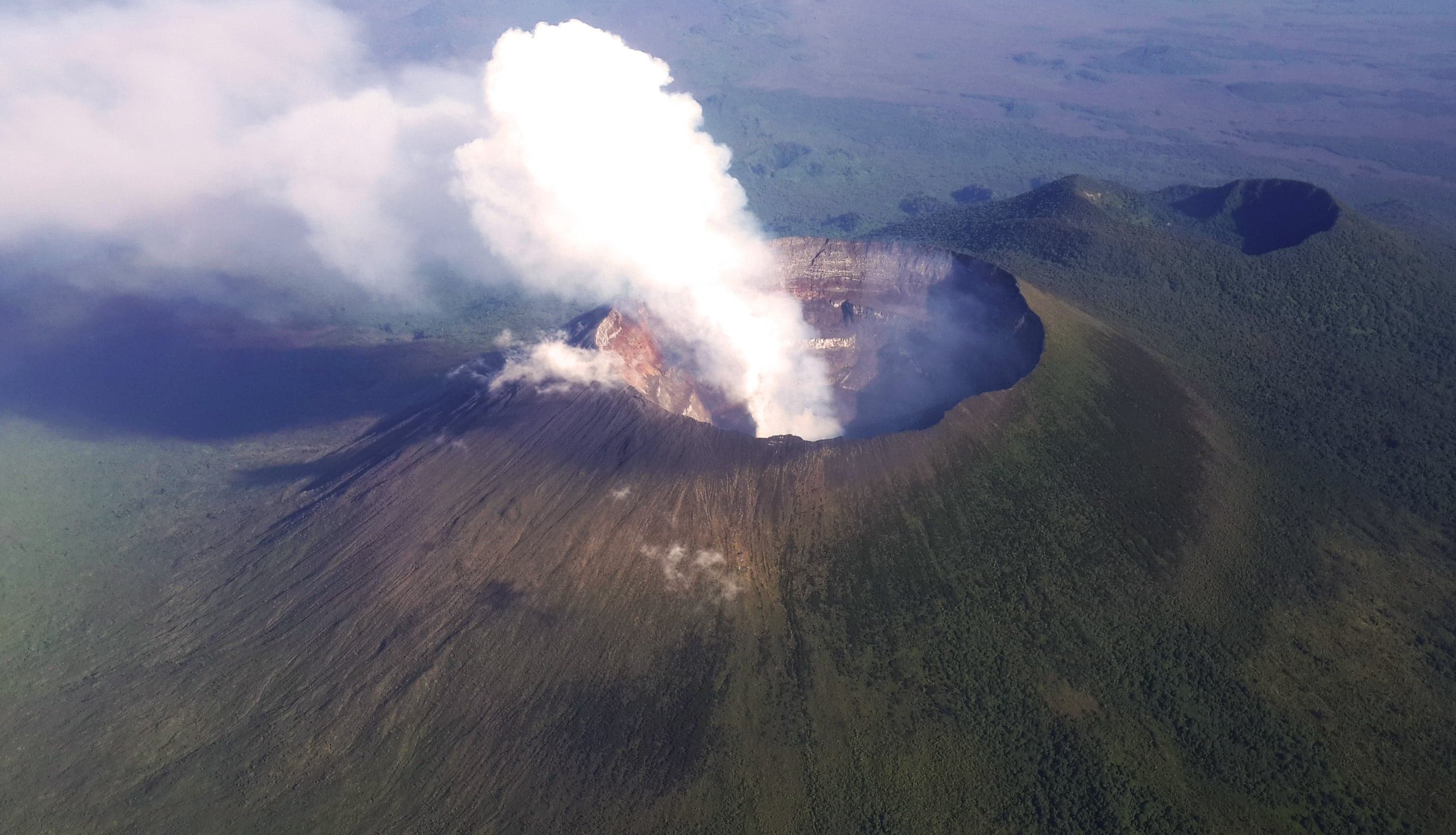 Glowing orange lava lake inside the crater of Nyiragongo Volcano at night
