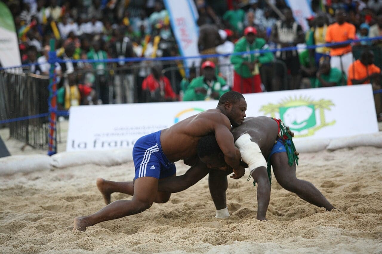 Two wrestlers competing in a traditional match at a village festival in Equatorial Guinea