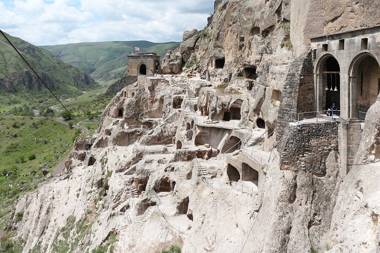 The Vardzia cave monastery carved into a rocky cliff with many openings visible