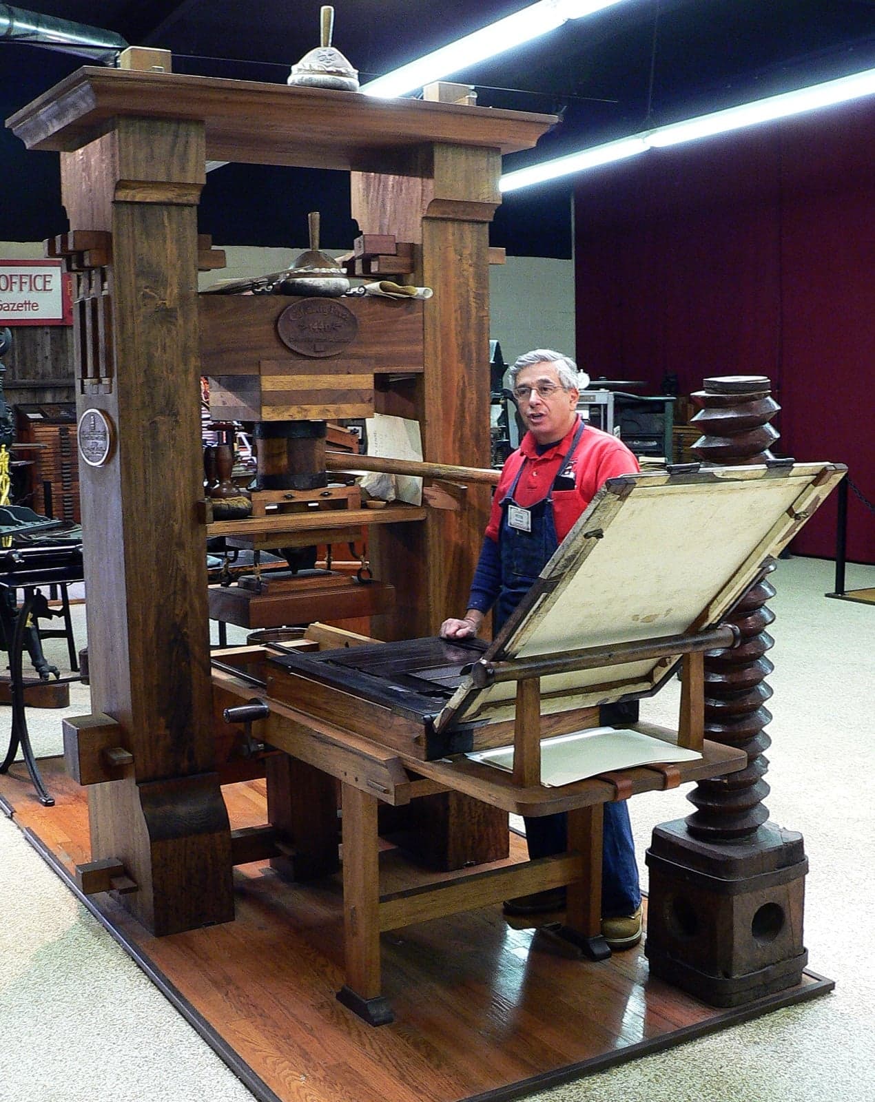 A wooden reproduction of an early printing press in a museum