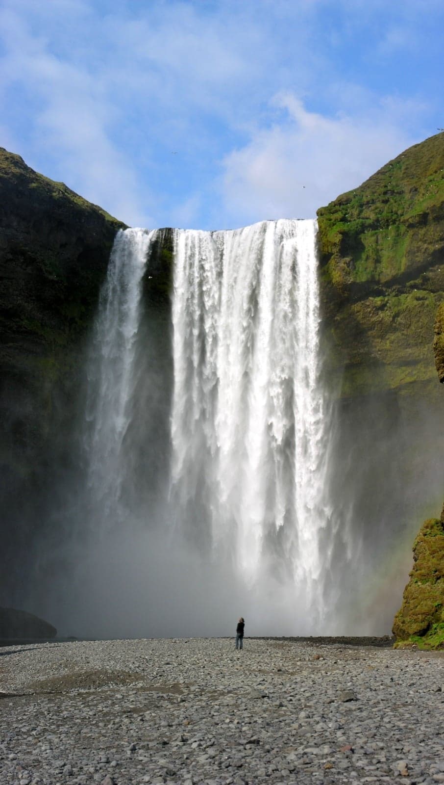 Skógafoss waterfall thundering down a vertical cliff in southern Iceland