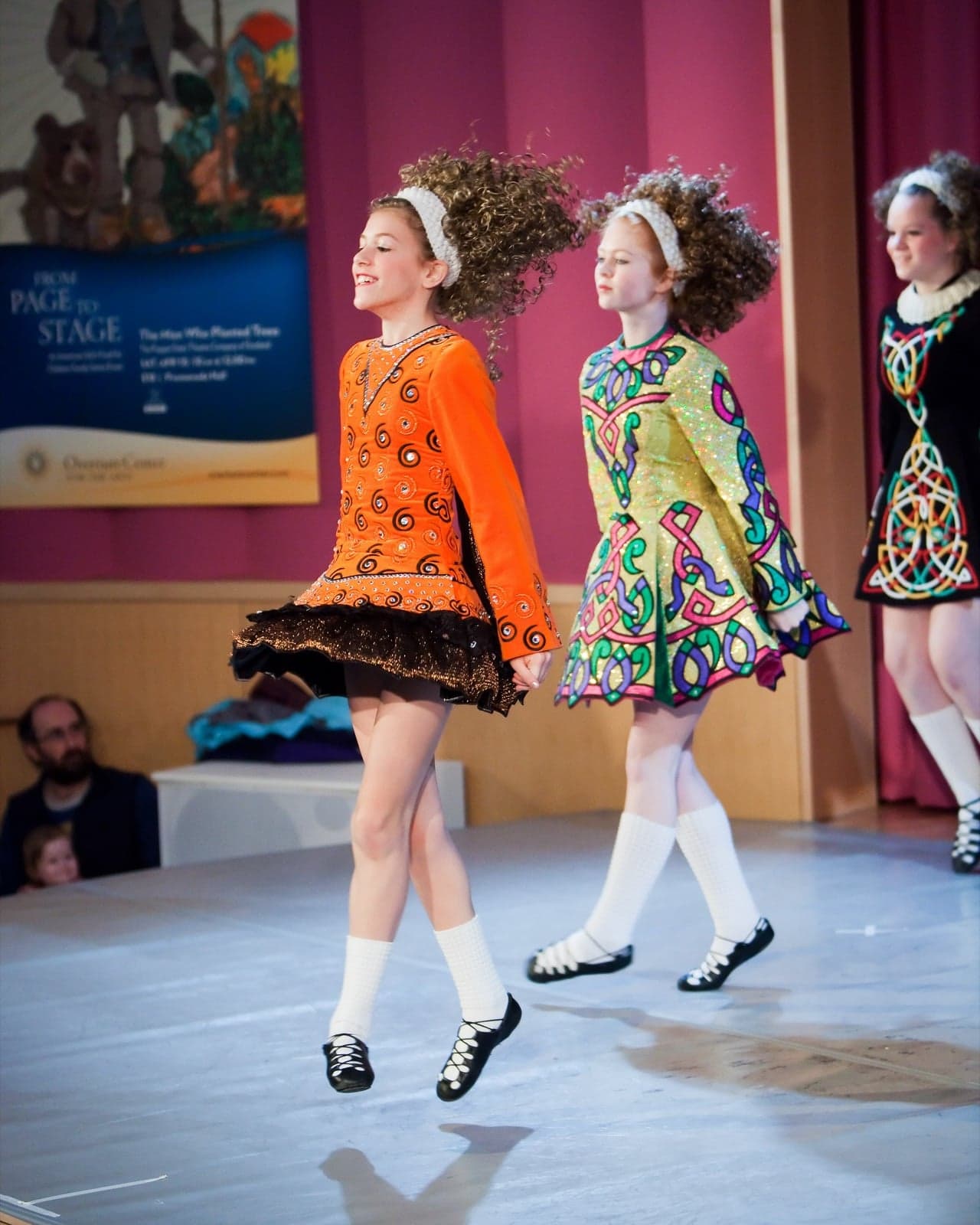 Children performing Irish step dancing in traditional dress