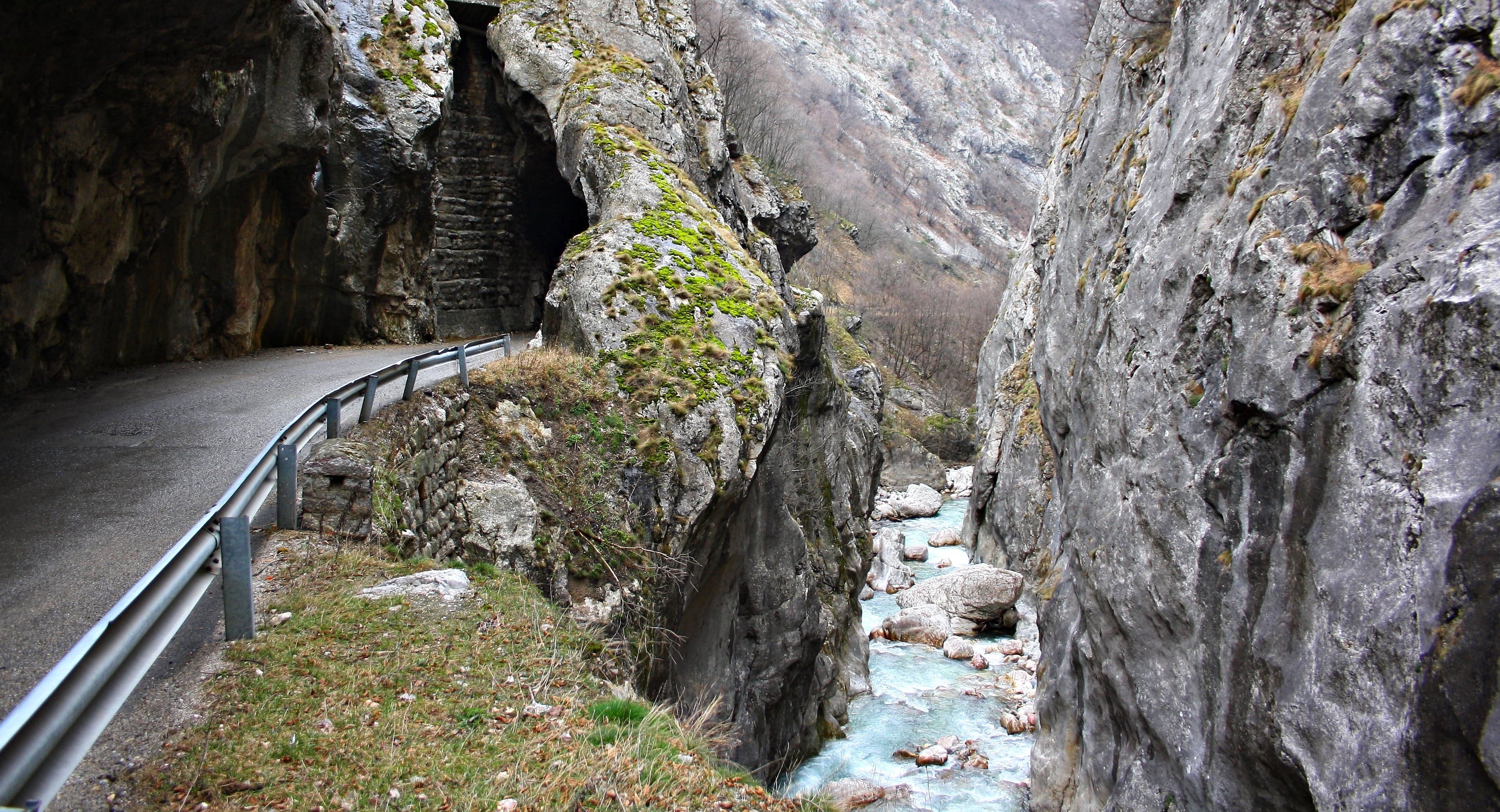 The steep limestone walls of Rugova Canyon rising above a turquoise river