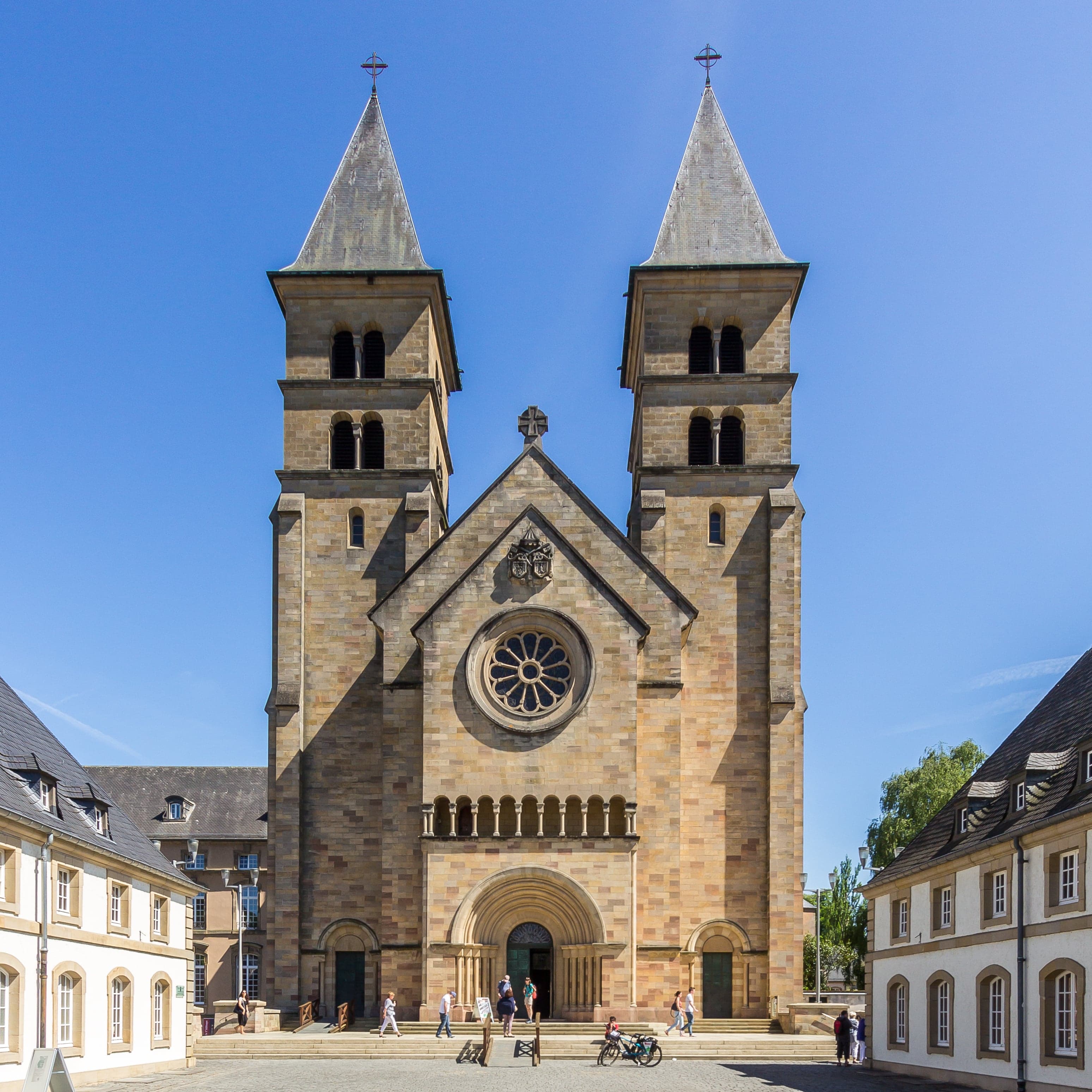 The cream-coloured facade of Echternach Abbey in the old town square