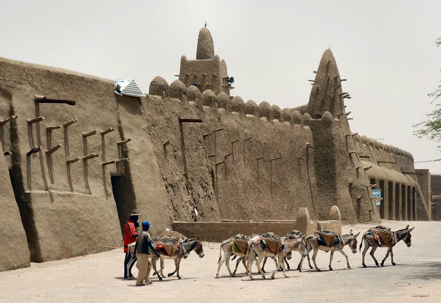 The Sankore mosque and sandy streets of Timbuktu at sunset