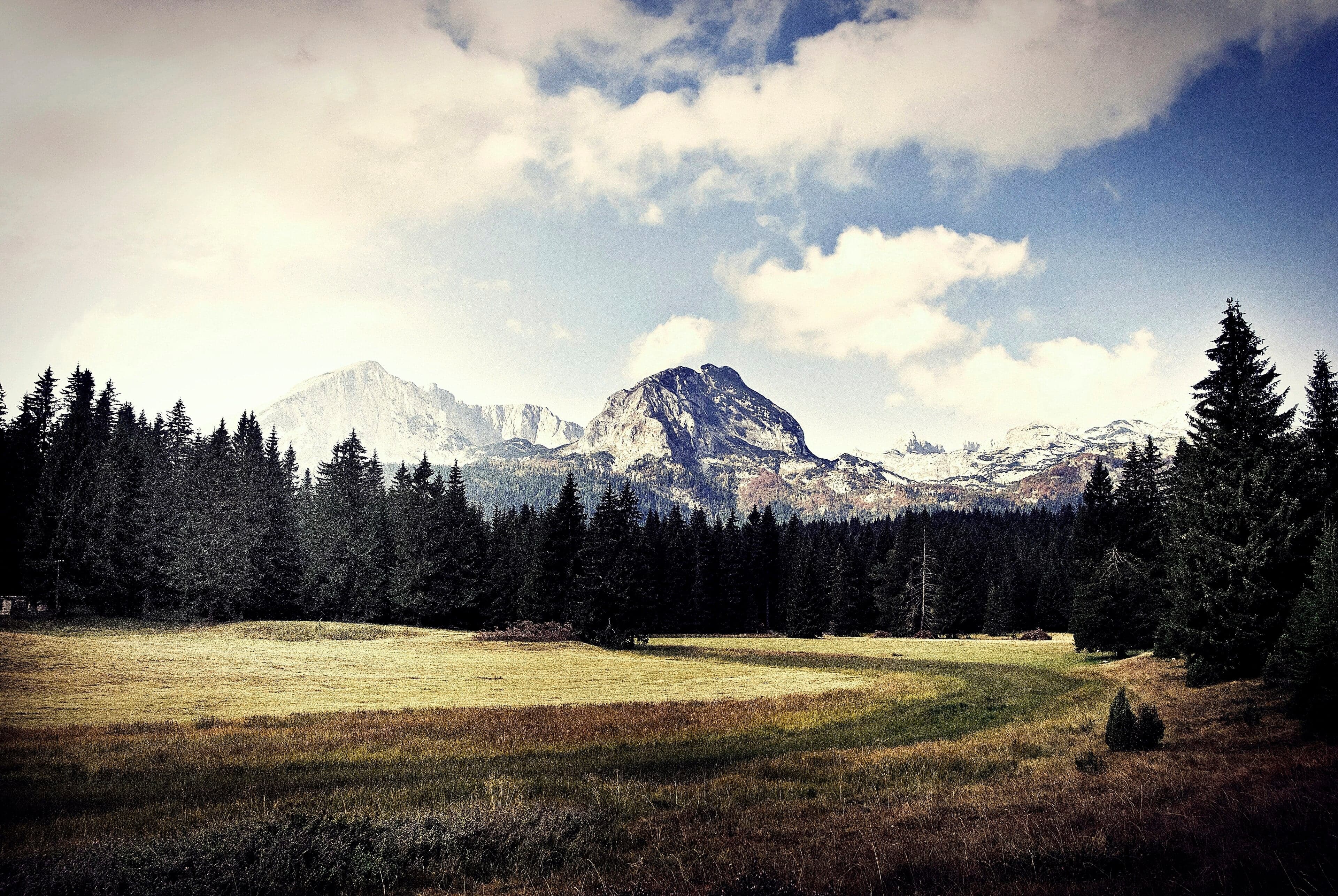Snow-capped peaks of Durmitor reflected in the still water of Black Lake