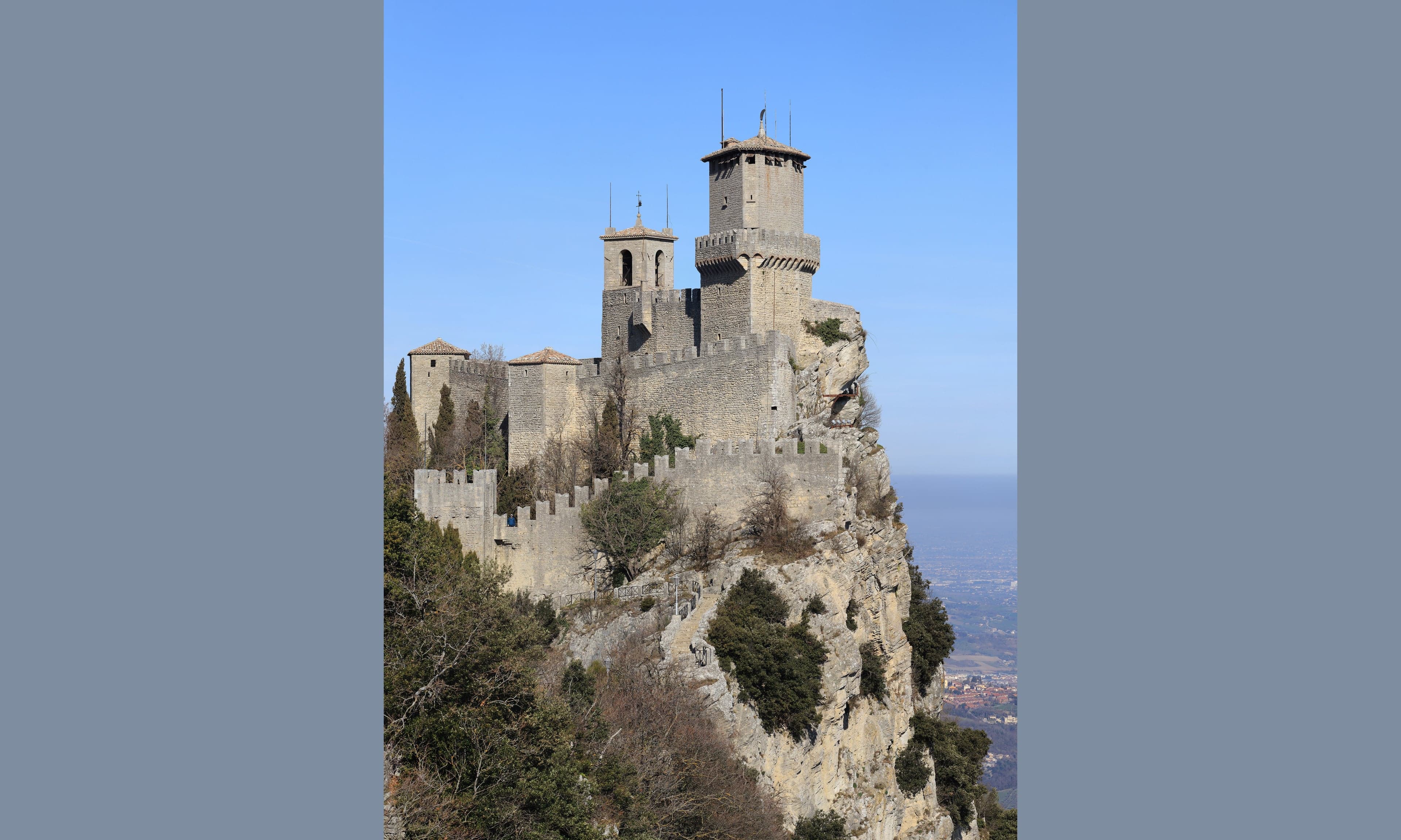 Guaita tower rising above the rocky cliffs of Mount Titano