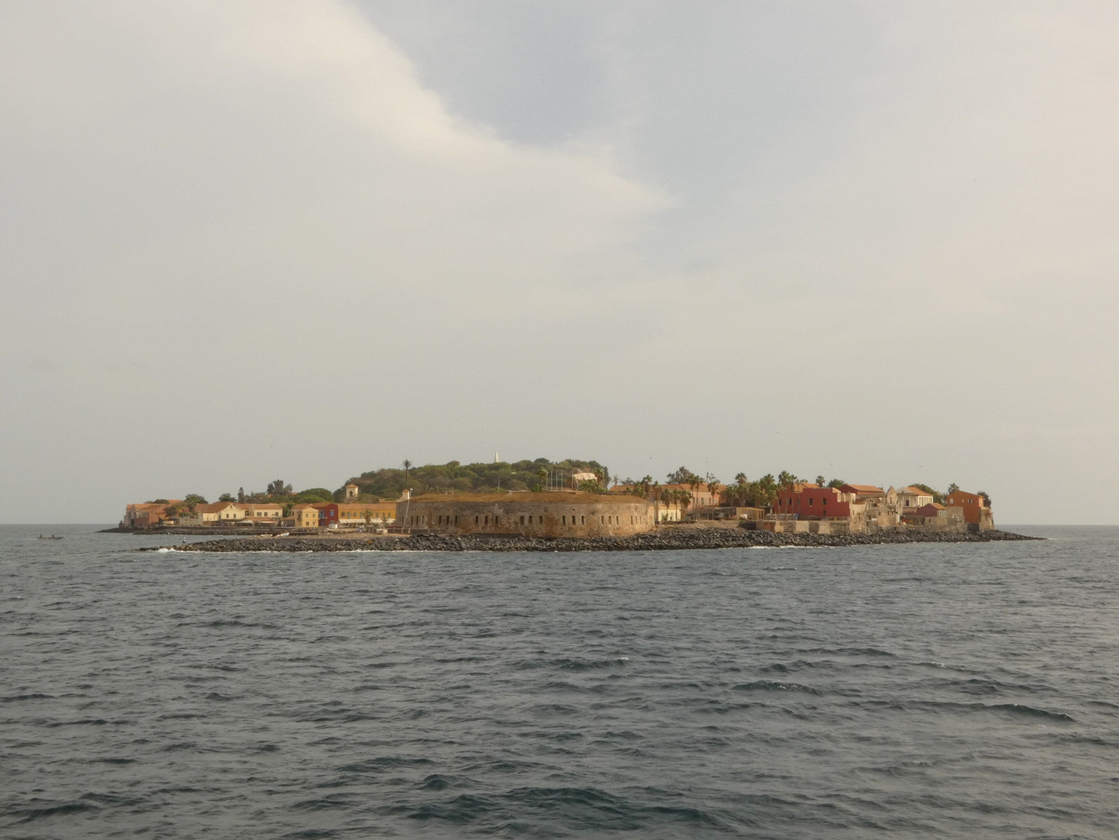 Pastel-coloured buildings and palm trees on Gorée Island