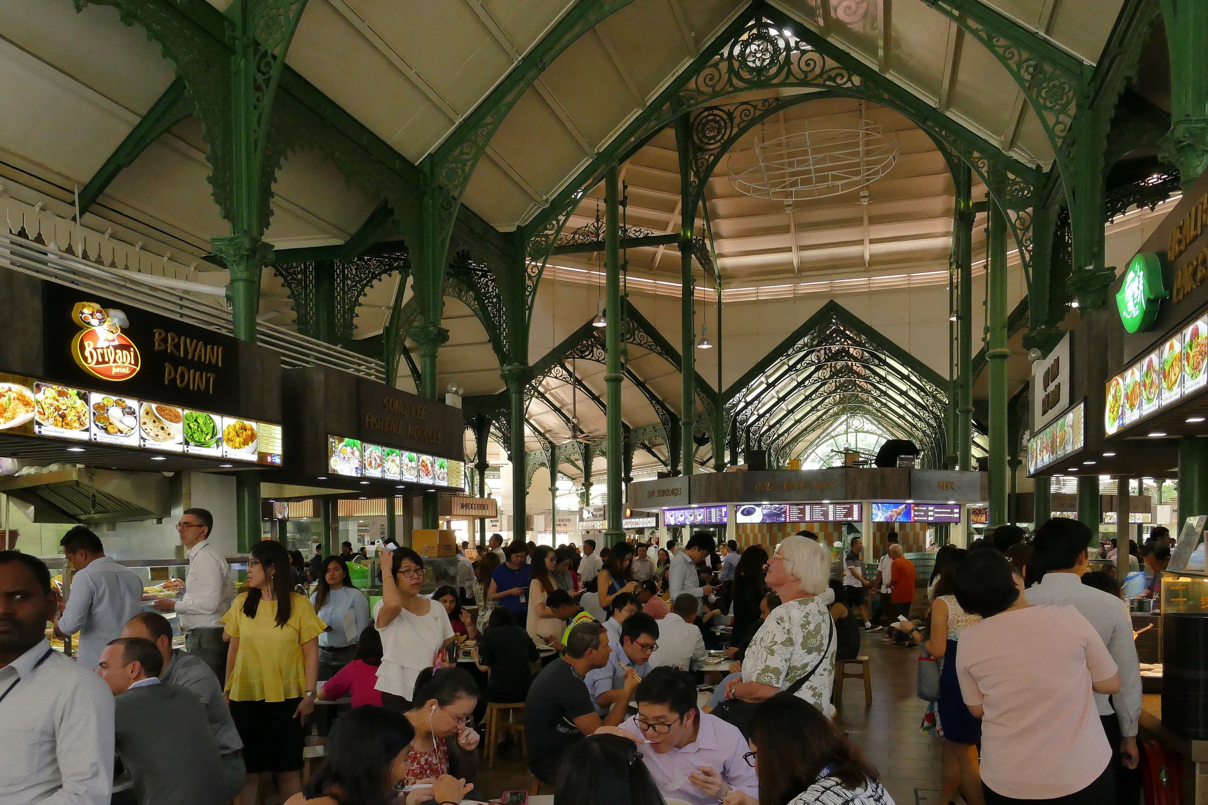 Inside a hawker centre in Singapore, with food stalls and seating