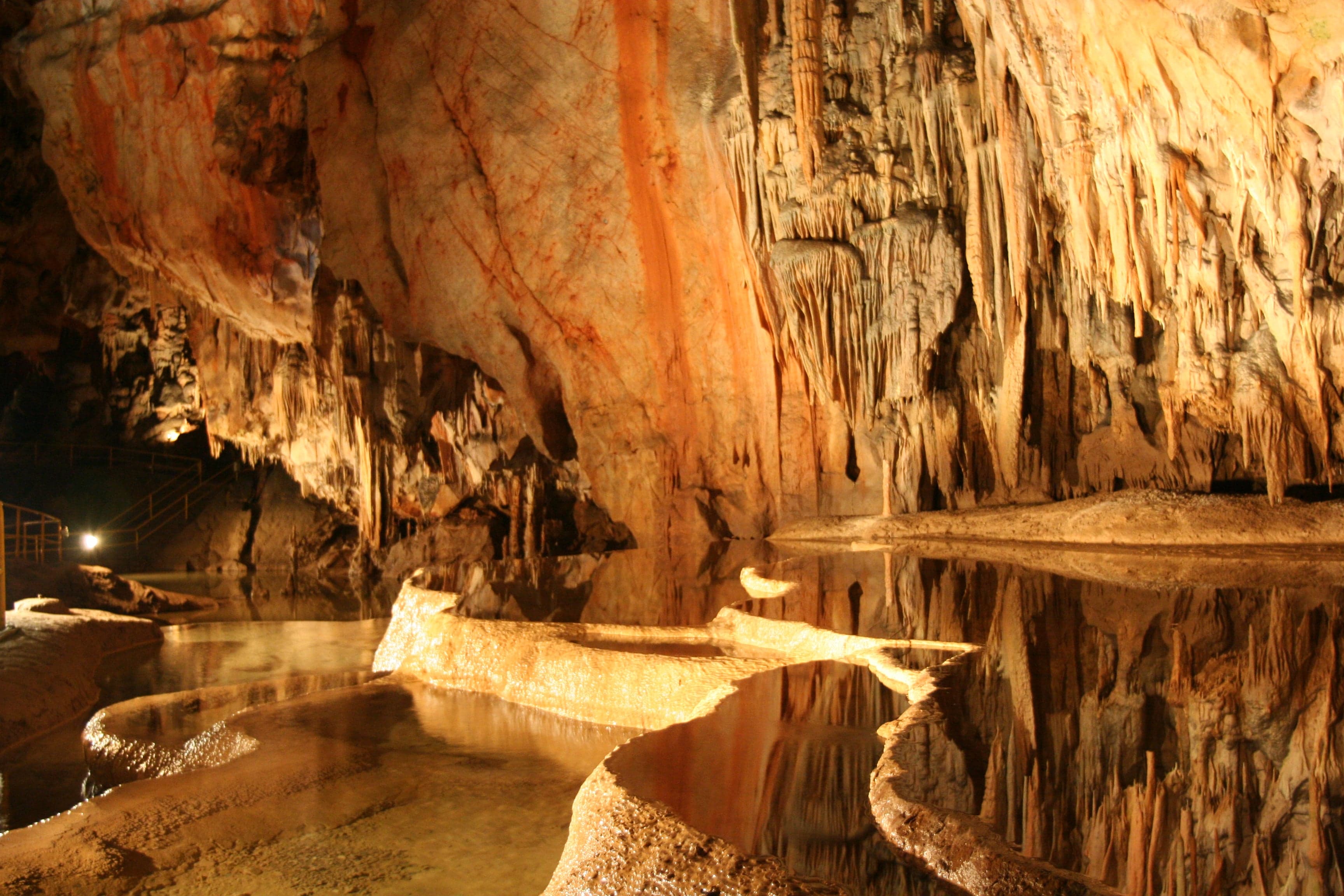 Pale rock formations and crystal pillars inside a Slovak cave
