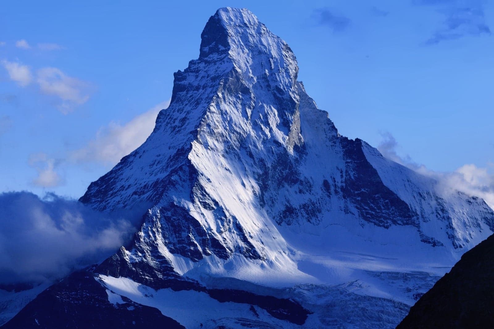 The Matterhorn's sharp, four-sided pyramid peak rising above snow