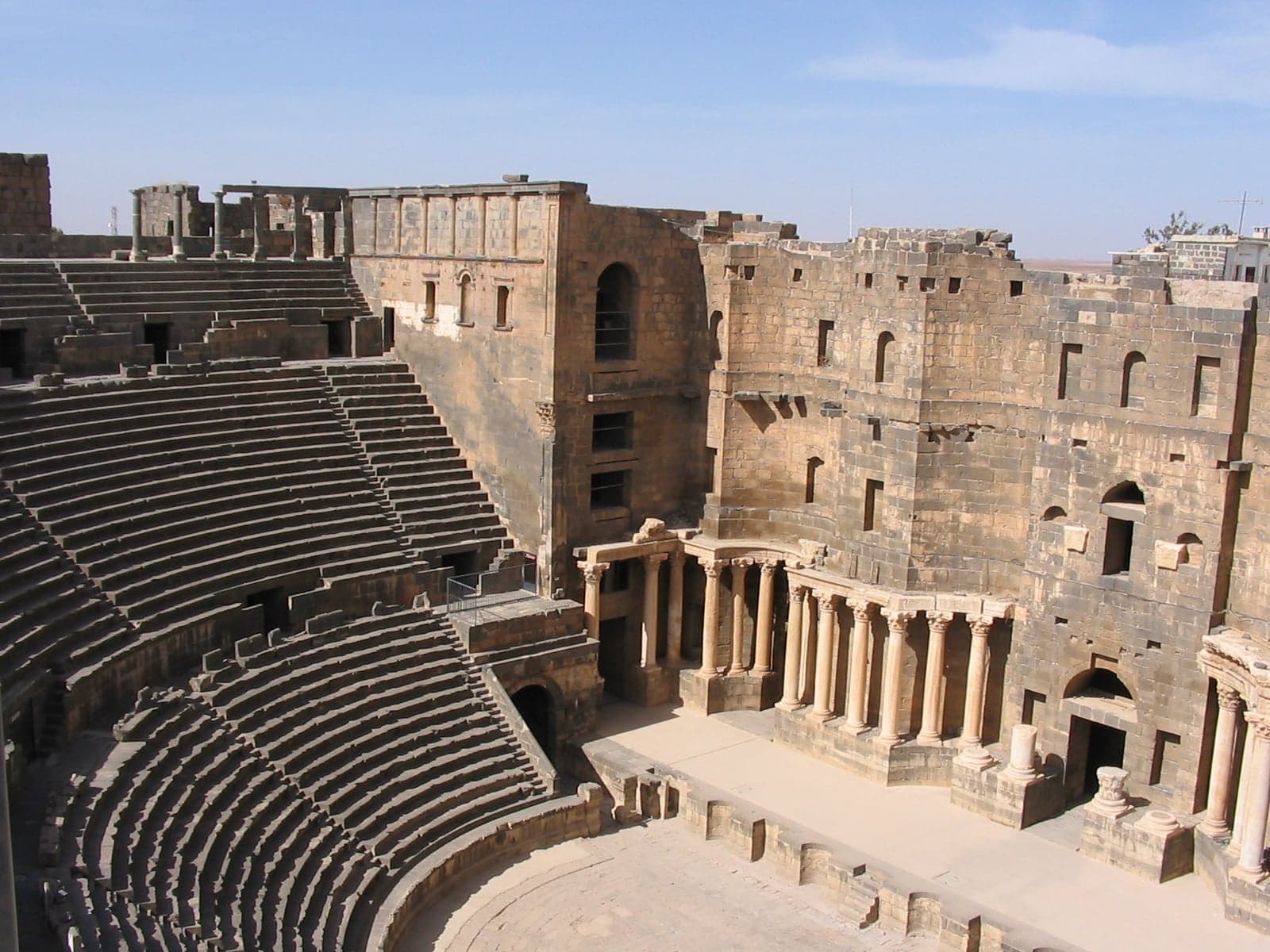 The massive semicircular stone seating of Bosra's Roman theatre