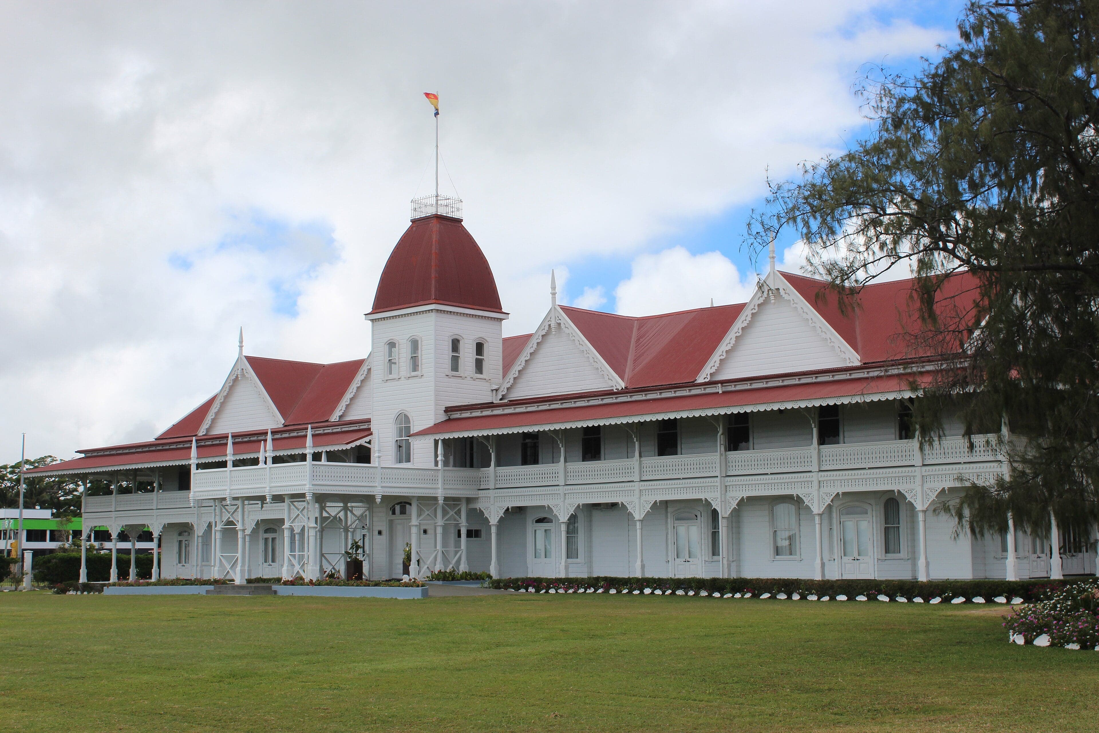 The white wooden Royal Palace of Tonga surrounded by green lawns in Nuku'alofa