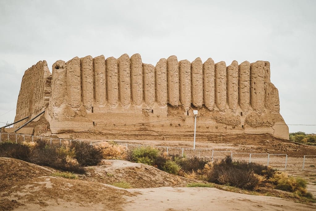 The ancient mud-brick ruins and domed mausoleums of Merv stretching across flat desert