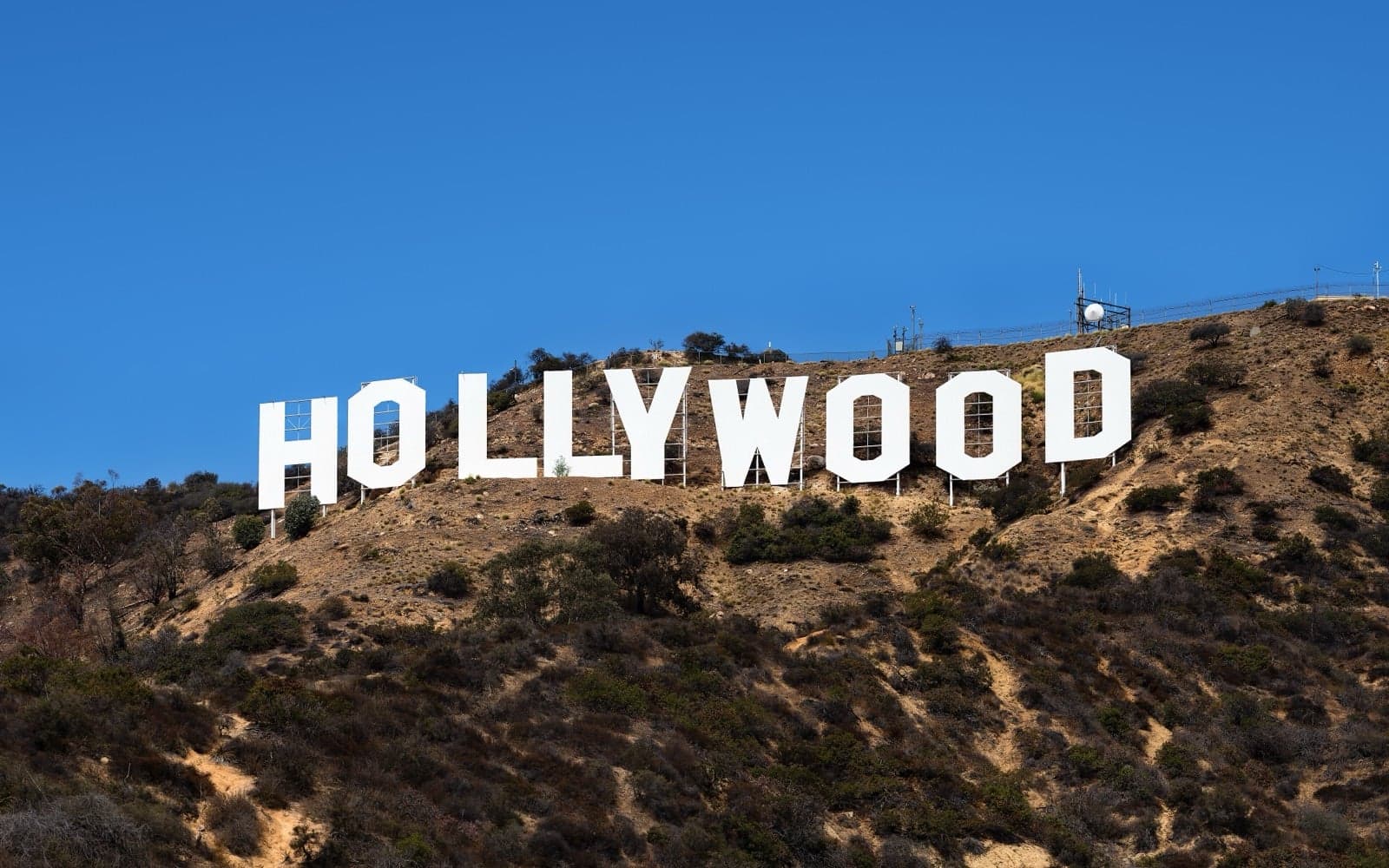 The famous Hollywood sign on a hillside under a blue sky