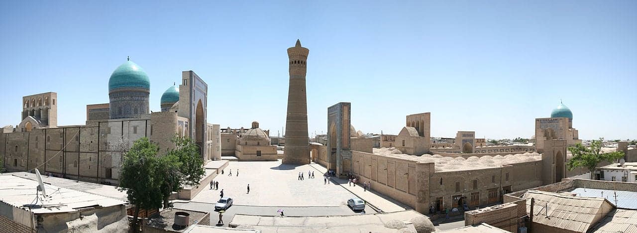 The tall Kalyan Minaret tower and old buildings of central Bukhara