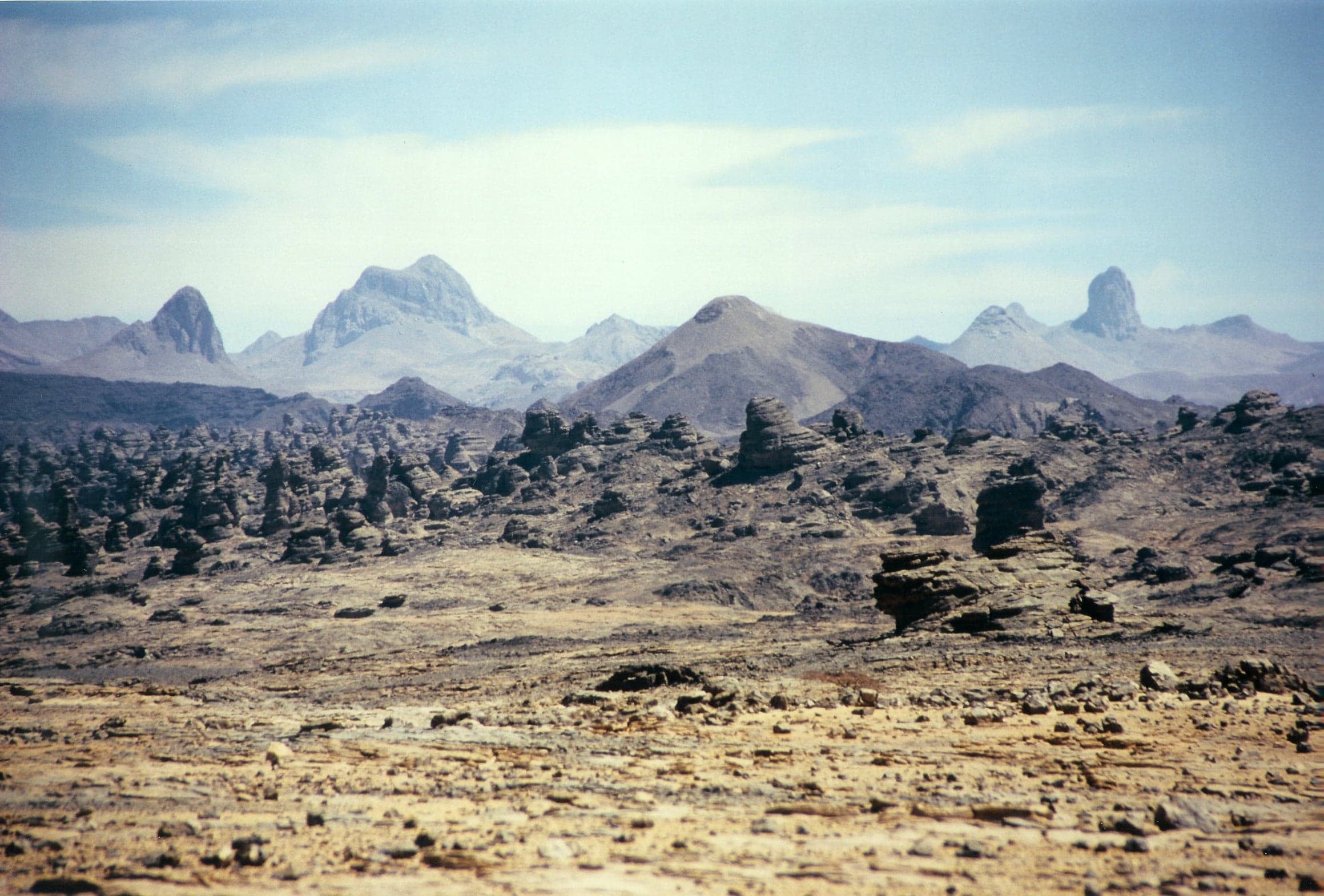 The dramatic volcanic peaks of the Tibesti Mountains rising steeply above the Saharan plain