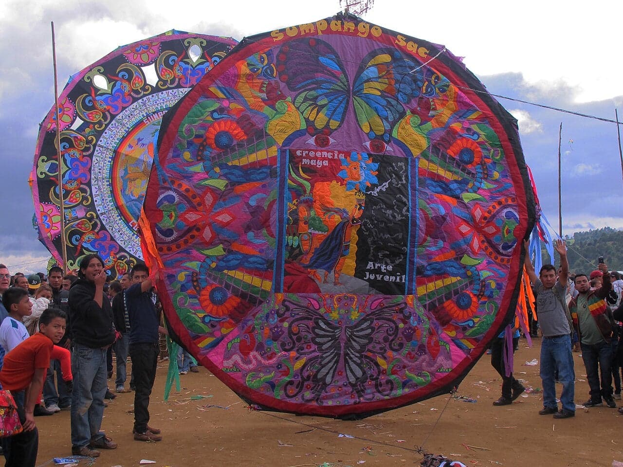 Enormous colourful paper kites flying above the hillside cemetery in Sumpango, Guatemala