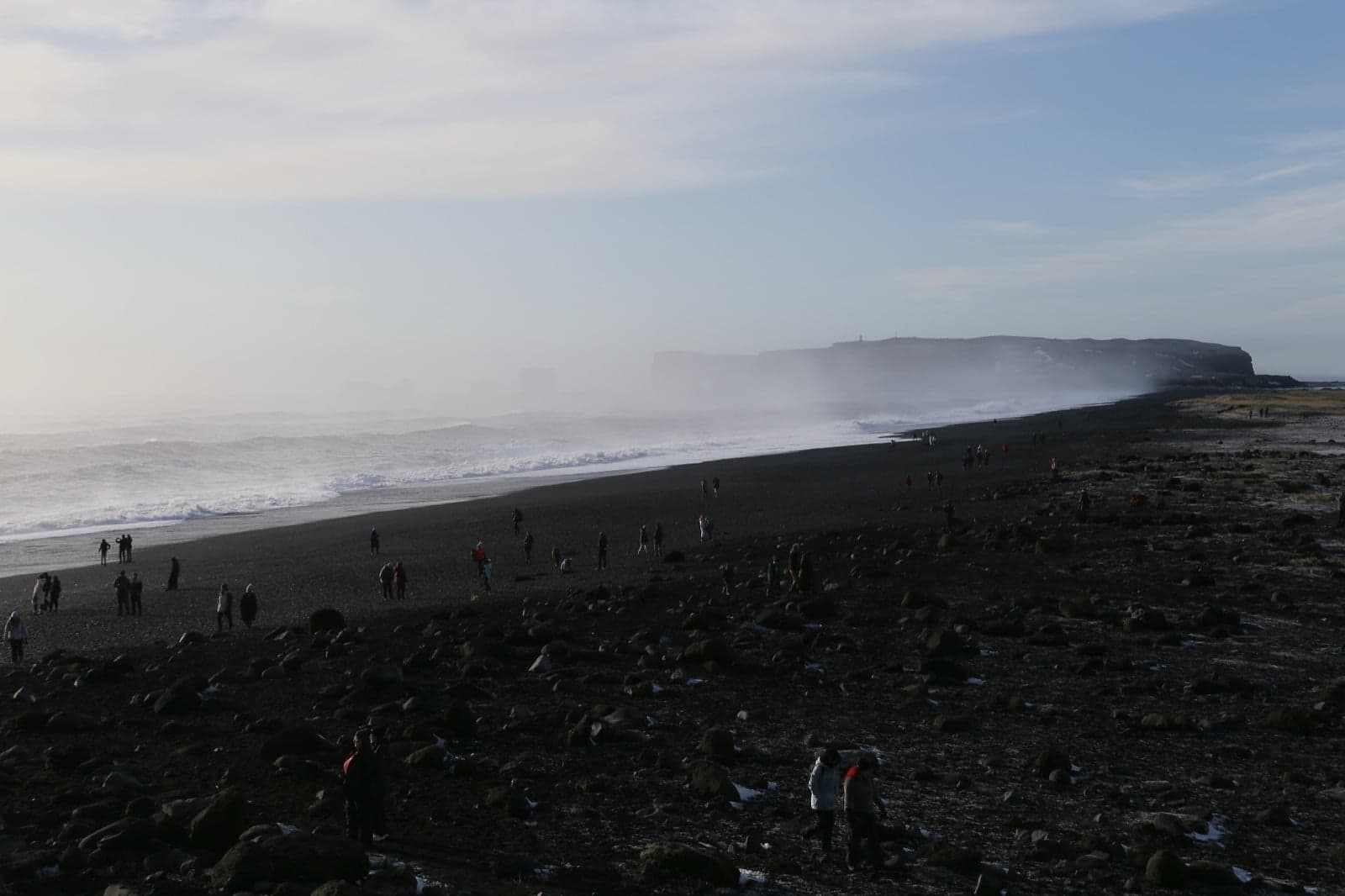 Reynisfjara black sand beach near Vík with basalt sea stacks rising from the waves
