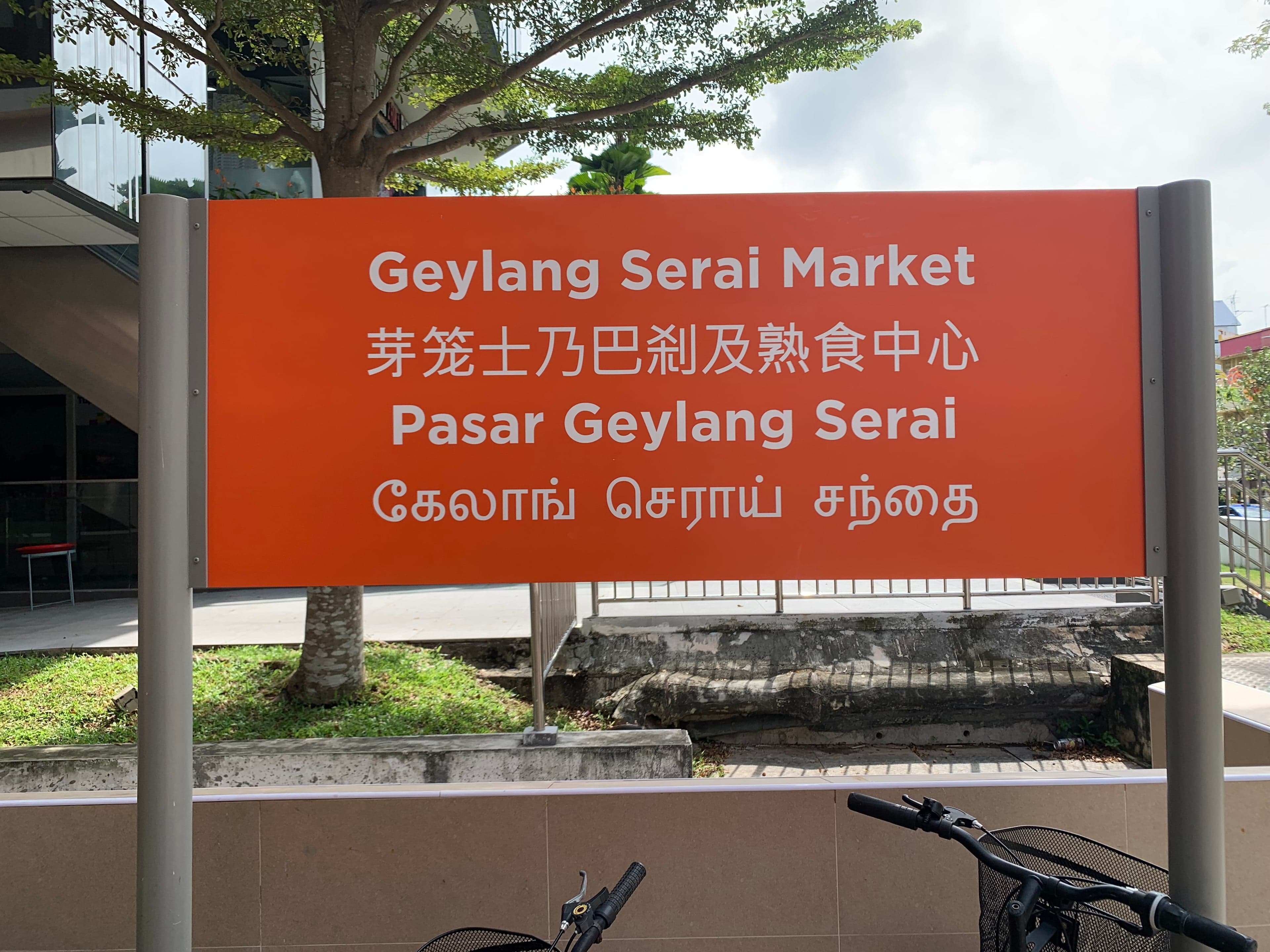 A Singapore market sign written in English, Chinese, Malay and Tamil