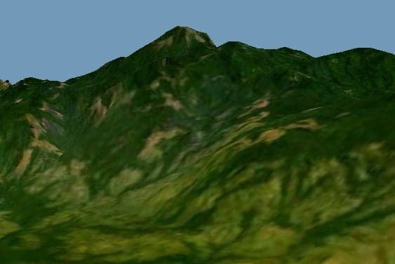 Misty forested ridges of the Imatong Mountains rising above the savannah